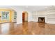 Spacious living area with hardwood floors, a fireplace, built-in shelving, and archways at 1757 Carlin Ave, Charleston, SC 29412