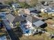 Enjoy the stunning aerial view of this home with an inviting pool, screened-in porch, patio, and well-manicured lawn at 1886 Capri Dr, Charleston, SC 29407