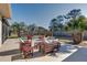 Outdoor space features patio, outdoor furniture, palm trees, and an inground swimming pool at 1886 Capri Dr, Charleston, SC 29407