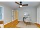 Bedroom features ceiling fan, hardwood floors, and a light neutral color palette at 1886 Capri Dr, Charleston, SC 29407