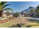 Landscaped front yard with palm trees accentuates this charming one-story home with a spacious driveway at 1886 Capri Dr, Charleston, SC 29407