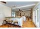 Open kitchen with granite counters, wood floors, and adjacent living area at 1886 Capri Dr, Charleston, SC 29407