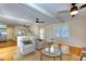 Bright living room with hardwood floors, a brick fireplace, and an open layout into the kitchen area at 1886 Capri Dr, Charleston, SC 29407