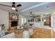 Cozy living room with a charming brick fireplace, hardwood floors and ample natural light at 1886 Capri Dr, Charleston, SC 29407