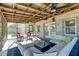 Comfortable, screened porch with contemporary outdoor seating and ceiling fan at 1886 Capri Dr, Charleston, SC 29407