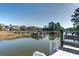 Scenic waterfront view featuring a private dock, lush reeds and the tranquility of coastal living at 1886 Capri Dr, Charleston, SC 29407