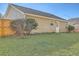 A view of the back of the house and the back yard, with grass and trees at 191 Blackstone Dr, Moncks Corner, SC 29461