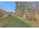 A view of the large back yard and fence, with grass and trees at 191 Blackstone Dr, Moncks Corner, SC 29461