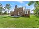 Spacious backyard showcasing a brick home, green lawn, and mature trees creating a serene environment at 203 Horseshoe Rd, Moncks Corner, SC 29461