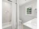 Elegant bathroom with marble tile, tub, and modern fixtures at 203 Horseshoe Rd, Moncks Corner, SC 29461