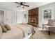 Main bedroom features brick fireplace, ceiling fan, plush carpet, and natural light at 203 Horseshoe Rd, Moncks Corner, SC 29461