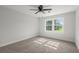 Bedroom featuring a ceiling fan, gray carpet and large window at 203 Horseshoe Rd, Moncks Corner, SC 29461