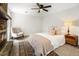 Cozy bedroom featuring a fireplace, ceiling fan, and stylish decor at 203 Horseshoe Rd, Moncks Corner, SC 29461