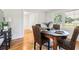 Dining room with a wooden table set for four, wicker chairs, and bright window at 203 Horseshoe Rd, Moncks Corner, SC 29461