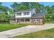 Charming two-story brick home with manicured lawn and an inviting front porch at 203 Horseshoe Rd, Moncks Corner, SC 29461