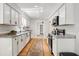 Galley kitchen featuring white cabinets, granite countertops, and stainless steel appliances at 203 Horseshoe Rd, Moncks Corner, SC 29461