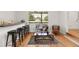 Bright sitting area with a window view, bar-top seating, and hardwood floors at 203 Horseshoe Rd, Moncks Corner, SC 29461