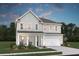 Charming two-story home featuring a symmetrical facade, a gabled roof, and an attached two-car garage at 2030 Mcguire Ln # 008, Hollywood, SC 29449