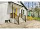 Backyard patio area featuring painted brick, yellow door and patio set at 204 Delano St, Saint George, SC 29477