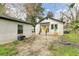 Charming backyard featuring a yellow door, patio set, and fire pit for outdoor gatherings at 204 Delano St, Saint George, SC 29477