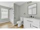 Bathroom with modern vanity, framed mirror, and tub with white tile surround and black hardware at 204 Delano St, Saint George, SC 29477