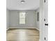Bedroom with new wood flooring and a window view at 204 Delano St, Saint George, SC 29477