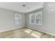 Bright bedroom with new wood flooring and two windows at 204 Delano St, Saint George, SC 29477