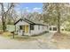 Charming bungalow with a bright yellow front door, detached two car garage and mature landscaping at 204 Delano St, Saint George, SC 29477
