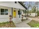 A welcoming porch with a bright yellow front door and well-maintained landscaping at 204 Delano St, Saint George, SC 29477