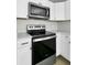 Well-equipped kitchen featuring stainless steel appliances and white cabinetry at 204 Delano St, Saint George, SC 29477