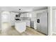 Modern kitchen with white cabinets, stainless steel appliances and a center island at 204 Delano St, Saint George, SC 29477