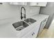 Modern kitchen with stainless steel sink, black faucet, white cabinets, and light countertop at 204 Delano St, Saint George, SC 29477