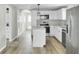 Modern kitchen featuring white cabinetry, stainless steel appliances, and an island at 204 Delano St, Saint George, SC 29477