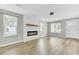Open living room with modern fireplace, wood floors, neutral paint, and lots of natural light at 204 Delano St, Saint George, SC 29477