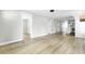 Open living room with wood floors, neutral paint and a view into the kitchen at 204 Delano St, Saint George, SC 29477