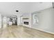 Bright living room with modern fireplace, wood floors and neutral paint at 204 Delano St, Saint George, SC 29477