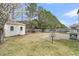 A spacious backyard with a storage building, patio, some grass and a disc golf basket at 233 Old Carolina Dr, Goose Creek, SC 29445