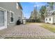 This backyard features a stone patio, grill, shed, and plenty of space for outdoor enjoyment at 233 Old Carolina Dr, Goose Creek, SC 29445