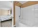 Bathroom view shows an oversized bathtub with shower and a doorway view of the bedroom at 233 Old Carolina Dr, Goose Creek, SC 29445