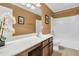 Well-lit bathroom features a white vanity top, dark wood cabinets, and a shower-tub combo at 233 Old Carolina Dr, Goose Creek, SC 29445