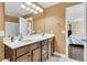 Bathroom boasts double vanity, large mirror, and a doorway view of the bedroom at 233 Old Carolina Dr, Goose Creek, SC 29445