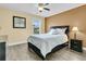 Comfortable bedroom with a dark bed frame, wood floors and light-colored walls at 233 Old Carolina Dr, Goose Creek, SC 29445