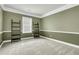Neutral bedroom featuring white trim, neutral carpet, a window and two decorative ladders at 233 Old Carolina Dr, Goose Creek, SC 29445