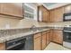 Efficient kitchen with wood cabinets, granite countertops, and stainless steel dishwasher and range at 233 Old Carolina Dr, Goose Creek, SC 29445