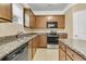 Functional kitchen with wood cabinets, granite counters, and a suite of stainless steel appliances at 233 Old Carolina Dr, Goose Creek, SC 29445