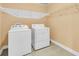 Efficient laundry area featuring a washer, dryer, and wire shelving for organized storage at 233 Old Carolina Dr, Goose Creek, SC 29445