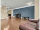 Stylish living room with hardwood floors, a navy accent wall, and elegant decor elements at 233 Old Carolina Dr, Goose Creek, SC 29445