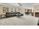 Bright living room with plush carpeting, a large sofa, and an open layout connecting to the kitchen at 233 Old Carolina Dr, Goose Creek, SC 29445