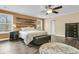Inviting bedroom with wood floors, wood accent wall, and windows offering natural light at 233 Old Carolina Dr, Goose Creek, SC 29445