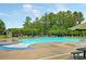 A beautiful, large community pool with lounge chairs and lush trees around the perimeter at 233 Old Carolina Dr, Goose Creek, SC 29445